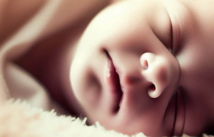 Newborn baby lying peacefully on a blanket