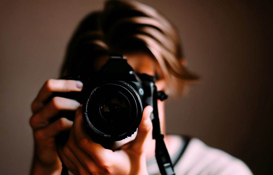 Person taking portrait photograph with camera